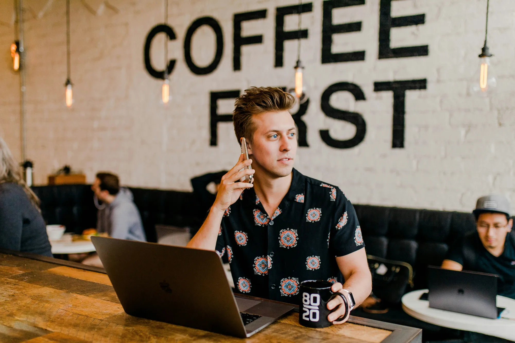 man on phone with a laptop