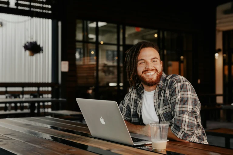 smiling man at a laptop