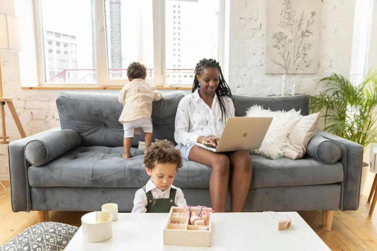 woman of colour working from home with children