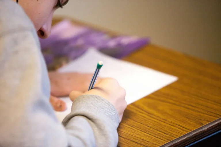person writing on paper