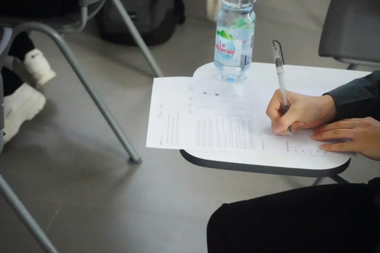 person writing a test or exam